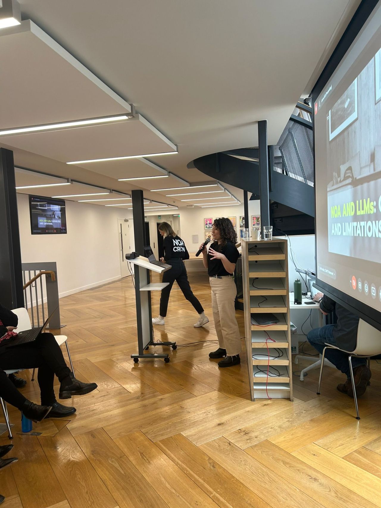 Ema Ilic on stage presenting on LLM capabilities at Pan Macmillan